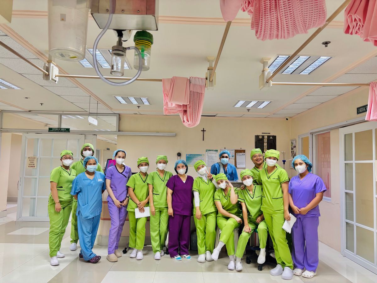 A hospital team in scrubs gathered on a ward.